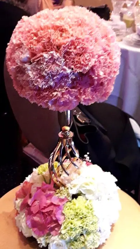 Pink carnation sphere on a gilded stand