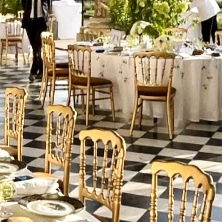 Gilded Napoleon chairs on a chequered floor