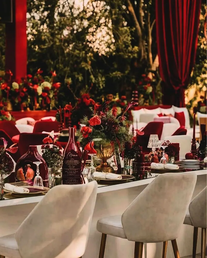 Garden dinner — red roses, burgundy velvet, ivory chairs
